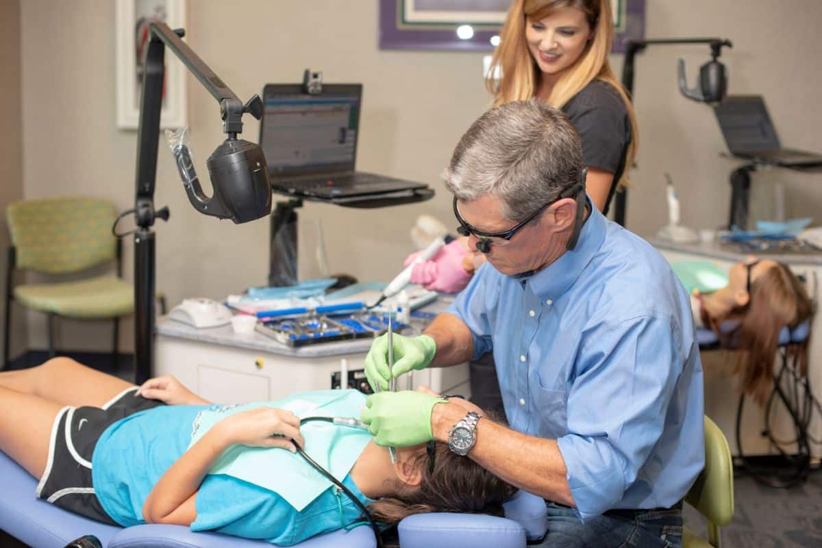 Dr. Buttram working on a patient's teeth